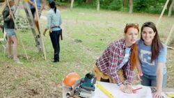 Volunteers reviewing blueprint at construction site Stock Footage