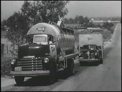 Montage: 1950 Chevy truck loads, hauls grain Stock Footage