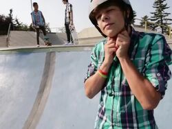 Teenage boy putting bicycle helmet on Stock Footage