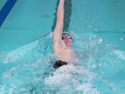 HD Super Slo-Mo: Young Male Swimmer at Backstroke Stock Footage