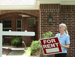 Real estate agent places 'For Rent' sign. Home. Stock Footage