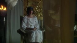 Ancient Egyptian young male wearing gold necklace sitting on throne next to young female ancient Egyptian wearing white robes sitting on throne with fire burning in bowl Stock Footage