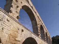 MS Bridge on river with plane in sky / Vers-Pont-du-Gard, Provence ,France Stock Footage