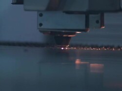 Close up of laser cutter as it glides across sheet of metal. Stock Footage