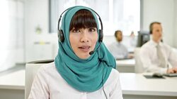 LD Female Muslim call center operator during a video call Stock Footage