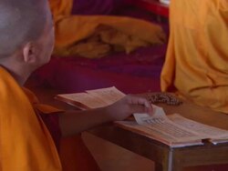 CU Boy in orange robes reading  prayers at  Buddhist monastery  AUDIO / Kathmandu, Central Region, Nepal  Stock Footage