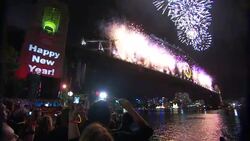 A sign counts down as fireworks explode during a New Year's celebration in Sydney, Australia. Stock Footage
