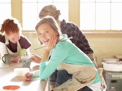 Students examining cup in pottery class Stock Footage