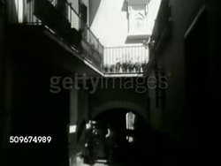 1942: U.S. CONSULATE IN FRANCE: HA XWS Ships in Tangier harbor. LA MS American flag on top of US consulate, Vichy. MS Alleyway (dark). INT MS US Diplomat Robert Daniel Murphy (1874-1978) at desk talking w/ French officials. MS Murphy talking. WWII Instructional Video
