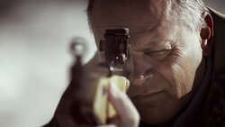 SLO MO man shooting a rifle Stock Footage