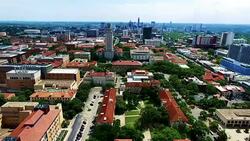 Extreme High Contrast Far Away shot with UT Tower and skyline in the distance Aerial Fly by Austin Texas Over University of Texas Stock Footage