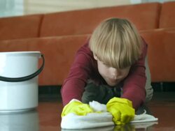 HD: Exhausted Boy Scrubbing The Floor Stock Footage