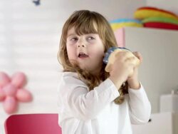 HD DOLLY: Little Girl Shaking Her Piggy Bank Stock Footage