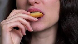 mouth of young beautiful woman eating biscuit at breakfast- close up Stock Footage
