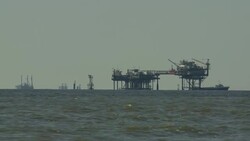 Seabirds fly around oil rigs that operate in the Gulf of Mexico. Stock Footage