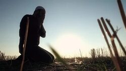 Islamic Man Prostrating In The Grass Stock Footage