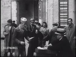 1940s: VATICAN CITY: MAIL DELIVERY: Citizens of Vatican City (Holy See) standing by building, handed mail, envelopes by seated man. HA XWS Palazzo del Govematorato (Governor's Palace). Instructional Video