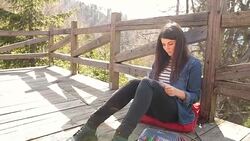 Young brown hair woman coloring a page from a book on her leisure time. Stock Footage