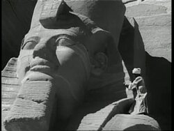 A man stands atop a giant statue of Ramses II in Abu Simel, Egypt. News Clip