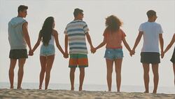 Friends hand in hand on the beach Stock Footage