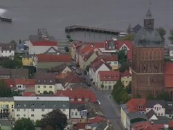 MS AERIAL Shot of buildings with car parking area with Saint Mary's church at Ribnitz-Damgarten / Germany Stock Footage