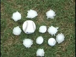 CU High angle, collection of huge hail stones gathered alongside golf ball & baseball, USA Stock Footage