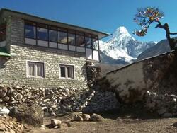 Teahouse with flags near Ama Dablam in the Himalayas. Stock Footage