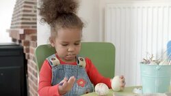 HD: Happy Little Girl Painting Easter Eggs Stock Footage