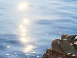 HD SLOW MOTION: Flip-Flops Against Sea Waves Stock Footage