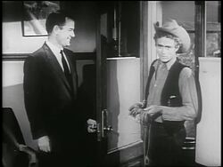 B/W 1955 Gig Young + James Dean stand by doorway / James Dean talks to camera + exits / PSA Stock Footage