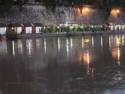 Enlightened stands along Tiber River bank by night, Rome Stock Footage