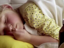 Little girl lying sick in her bed, sleeping Stock Footage