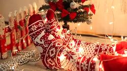 Woman's legs in seasonal winter socks by th Christmas decoration Stock Footage