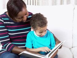 HD: African American Carer Reading To Little Boy Stock Footage