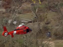 Aerial fire patrol Aerospatiale Dauphin helicopter flying over ruined neighborhood / Waveland, medium shot Stock Footage