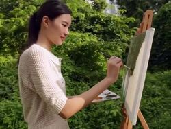 MS woman painting on an easel outdoors. Stock Footage