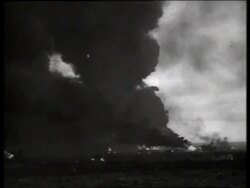B/W 1960's wide shot of heavy smoke and fire at air base / Vietnam / SOUND Stock Footage