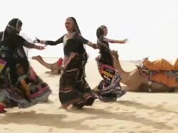 Three women dancing on desert, Sam Desert, Jaisalmer, Rajasthan, India Stock Footage