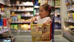 baby girl in shopping cart sitting and demanding Stock Footage