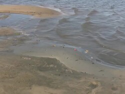 Waves Lapping into a Small Pool on Sandy Beach Stock Footage