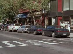 WS PAN view of man jogging on city street crosswalk and cars going on road  / Queens, New York, United States Stock Footage