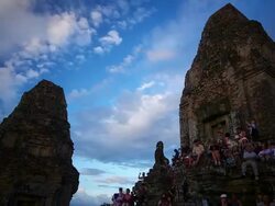 MS T/L LA Shot of Tourists at dusk sitting on Pre Rup temple, busy human activity as sky darkens / Angkor Wat, Cambodia Stock Footage