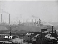 1947: US INDUSTRY: XWS Industrial factory w/ multiple stacks releasing white smoke, air filled w/ smoke. WS Closer same factory, possibly pulp, paper mill.  Environment, environmental, air pollution, pollutant, poison, waste, air quality, smog. Instructional Video