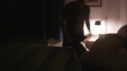 A man pulls down his bedclothes and  sits on the edge of his bed with his head in his hands. Stock Footage