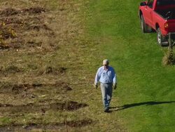 MS AERIAL ZI ZO PAN View of farmer working in farmland in Canterbury Shaker village / New Hampshire, United States Stock Footage
