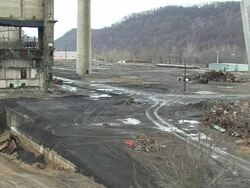 WS Tall factory building is demolished in controlled implosion using explosives / Weirton, West Virginia, USA Stock Footage