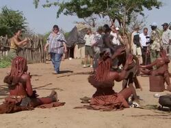 MS Shot of people from Imba Village on left side and tourists with guide visiting village on right / Imba Village, Namibia Stock Footage
