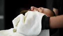 Close-up of beautiful attractive adult man with beard in a barber shop Stock Footage