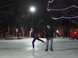 Couple has skating date on a snowy winter evening. Stock Footage