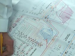 HD CRANE: Engineer reads blueprints Stock Footage